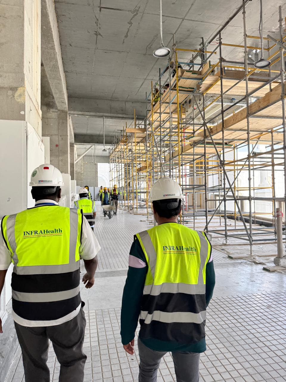 Infrastructure engineers inspecting an active construction site with scaffolding