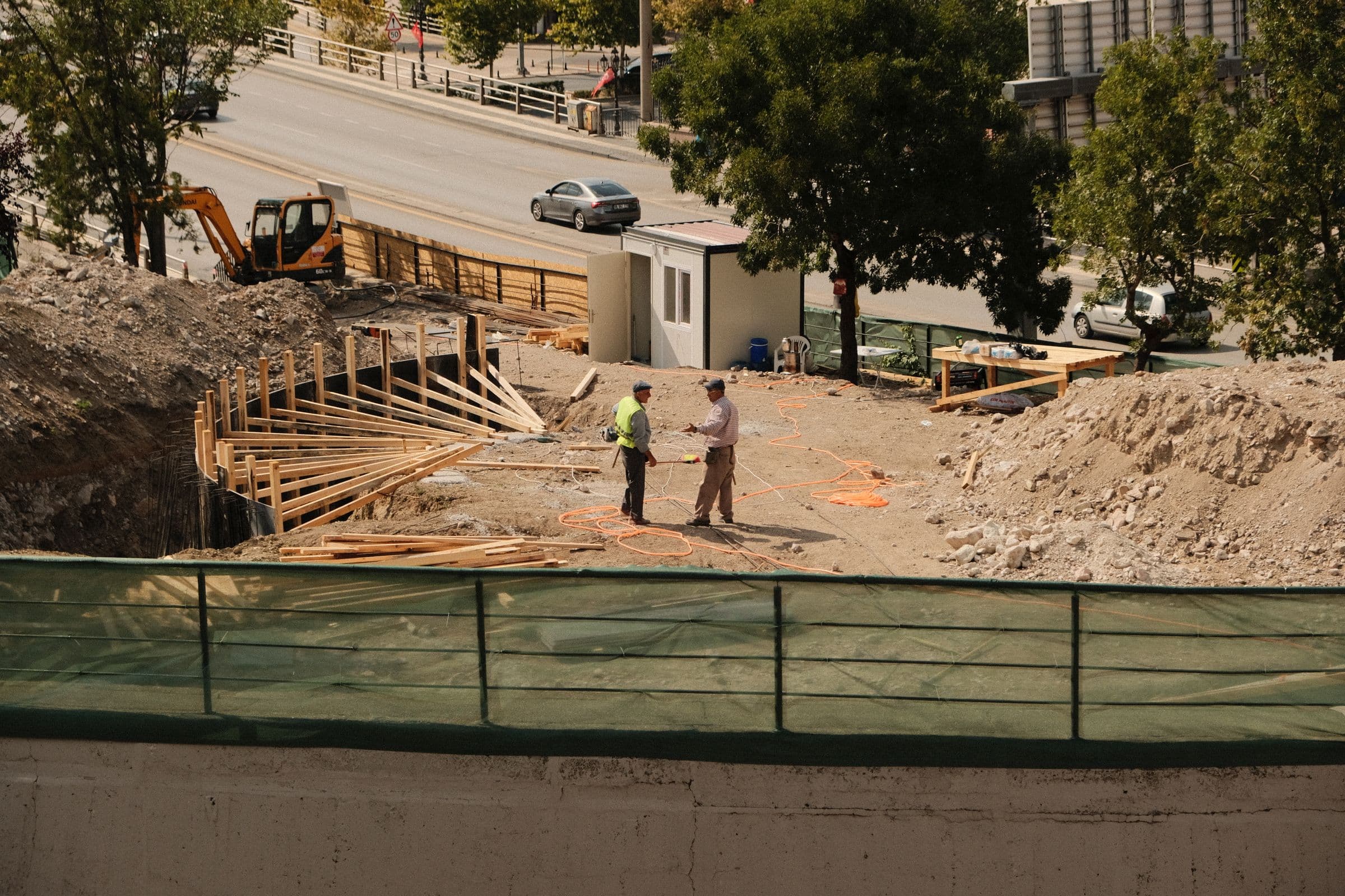 Construction engineers reviewing plans during an on-site quality inspection